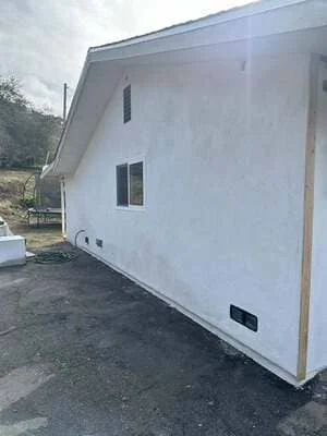 White residential addition with modern windows and clean exterior finish