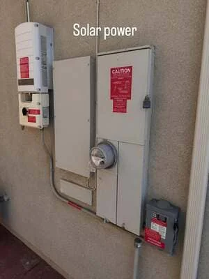 Solar power inverter and battery storage system mounted on interior wall with caution labels