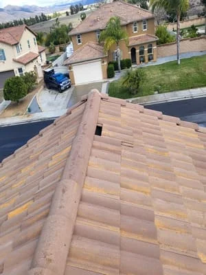 New clay tile roof installation on two-story home with varied earth-tone colors