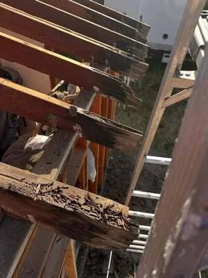 Multi-level residential deck under construction with wooden framing and composite decking