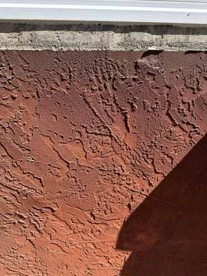 Compacted red soil foundation base with visible grading and stratification layers
