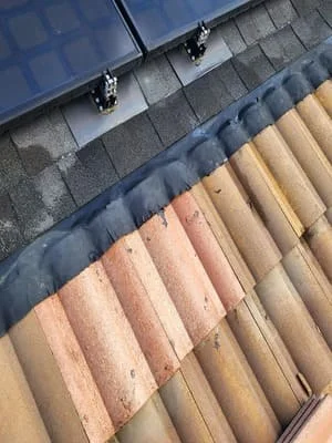 Roof installation displaying multiple asphalt shingle colors and proper underlayment application