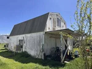 Restored barn with new metal roof and repaired wood siding in Temecula